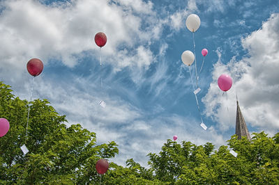 Low angle view of balloons against sky