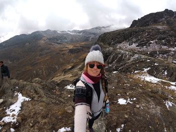 Man standing on mountain against sky