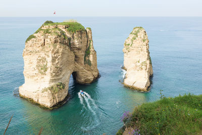 Rock formation on sea against sky