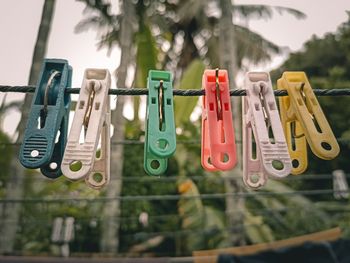 Close-up of clothespins hanging on clothesline