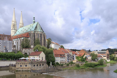 View of buildings against cloudy sky