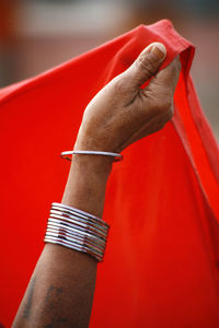 Close-up of man hand holding red background