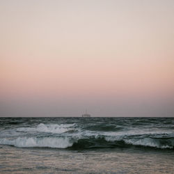 Scenic view of sea against clear sky during sunset