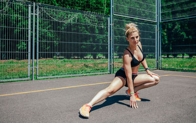 Full length portrait of smiling young woman