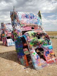 View of multi colored garbage at beach against sky