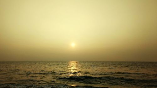 Scenic view of sea against clear sky during sunset