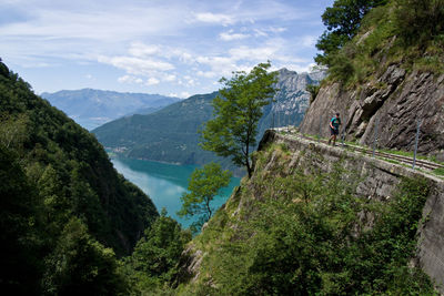 Scenic view of river amidst mountains against sky