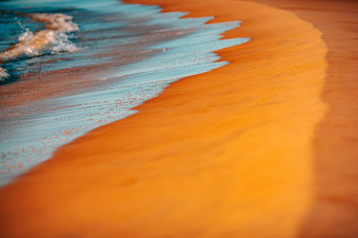 Surface level shot of sea waves on shore at beach