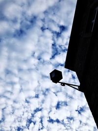 Low angle view of street light against building