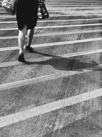 Low section of woman walking on steps