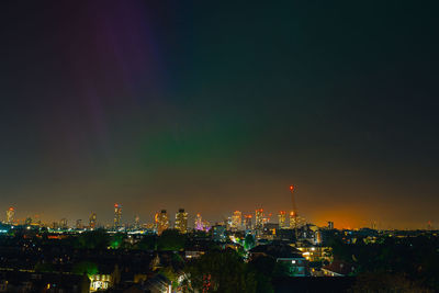 Illuminated cityscape against sky at night