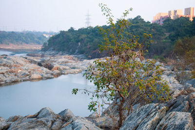 Scenic view of river amidst rocks against sky