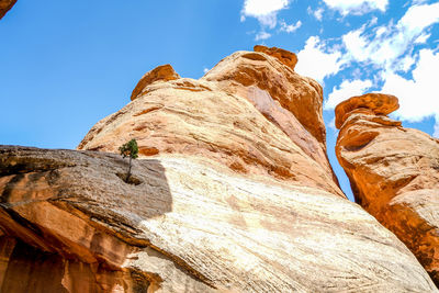 Rock formation on cliff against sky