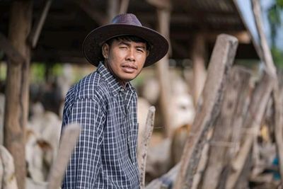 Portrait of man wearing hat standing outdoors