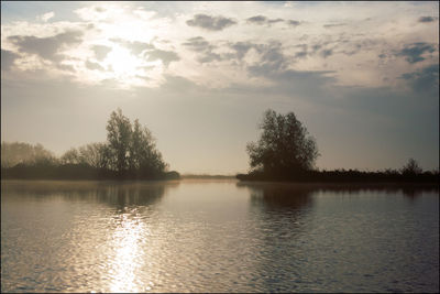 Scenic view of lake against sky during sunset