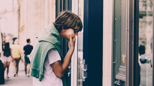 Side view of a boy standing outdoors