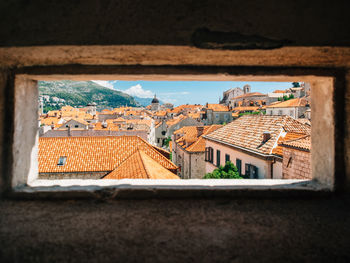 Residential buildings in town as seen through window