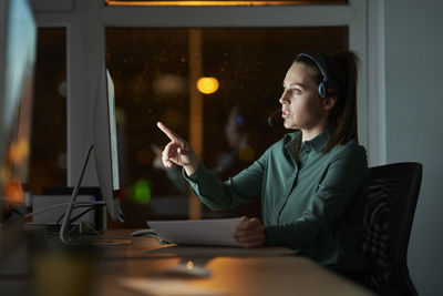 Businesswoman using laptop while sitting on table