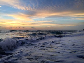 Scenic view of beach against sky during sunset