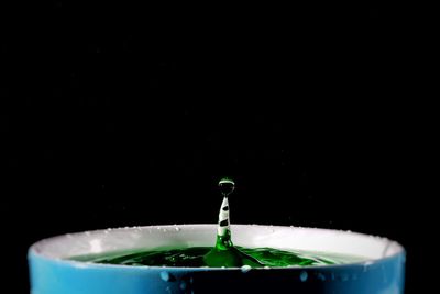 Close-up of water splashing against black background