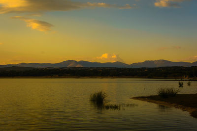 Scenic view of lake against sky during sunset