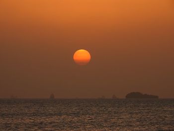 Scenic view of sea against orange sky