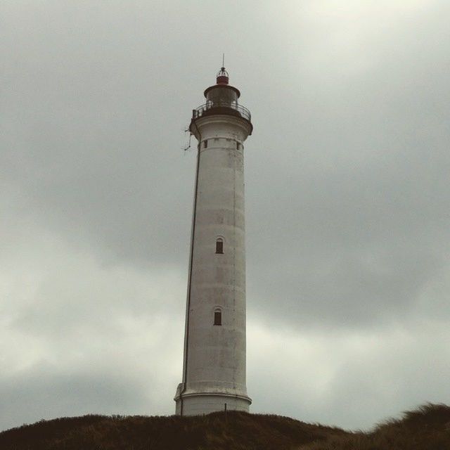 lighthouse, guidance, direction, tower, architecture, sky, built structure, low angle view, building exterior, protection, safety, security, cloud - sky, tall - high, cloudy, day, weather, outdoors, no people, nature