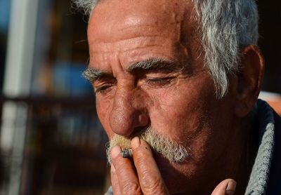 Close-up portrait of a man looking away