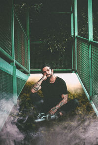Young man standing against wall