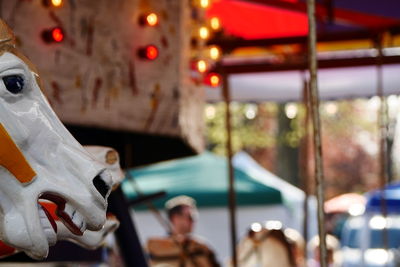 Close-up side view of cropped merry-go-round