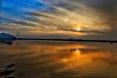 Scenic view of lake against sky during sunset