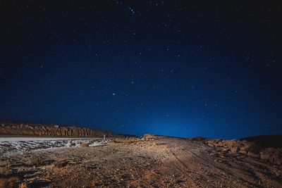 Scenic view of landscape against blue sky at night