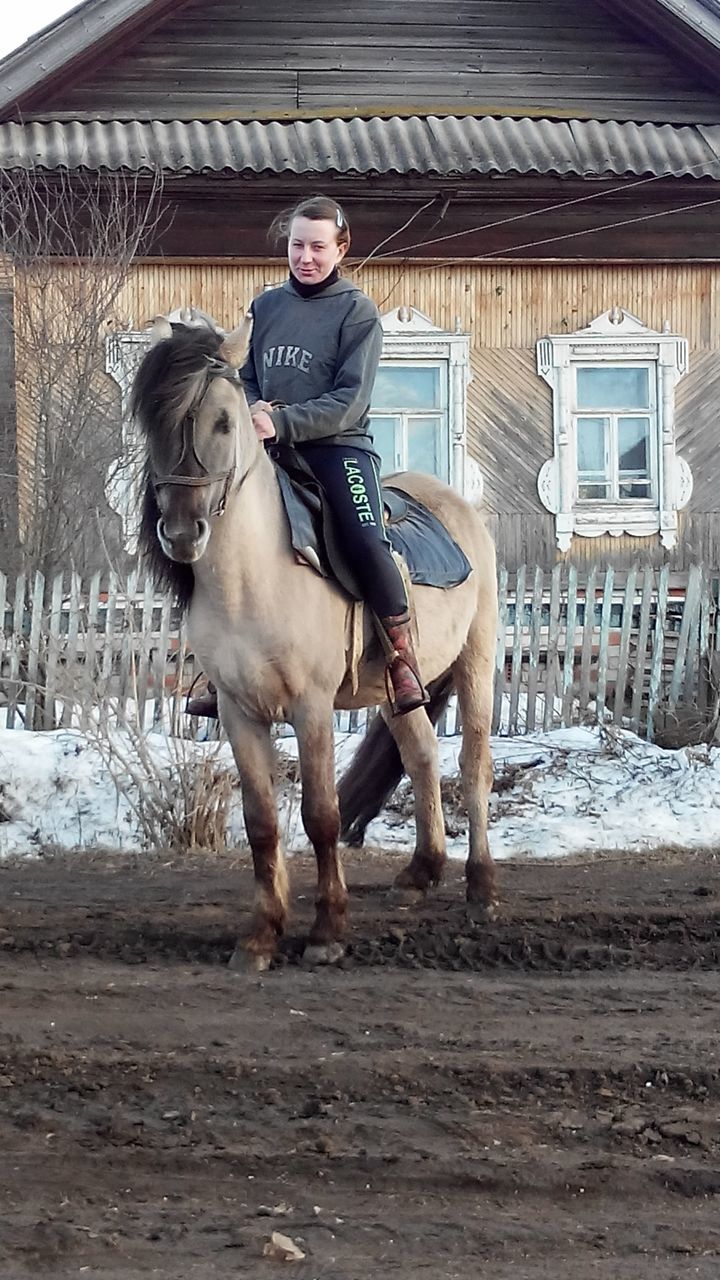 portrait, looking at camera, young men, young adult, domestic animals, full length, lifestyles, person, standing, animal themes, front view, horse, mammal, one animal, built structure, leisure activity, mid adult, mid adult men