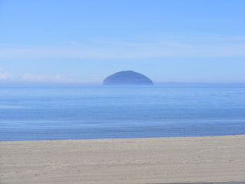 Scenic view of beach against blue sky