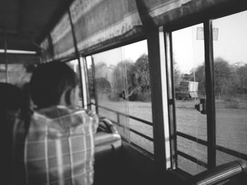 Close-up of people looking through train window