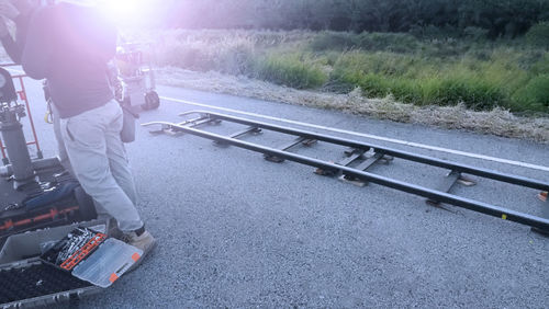 Rear view of man standing on railroad track