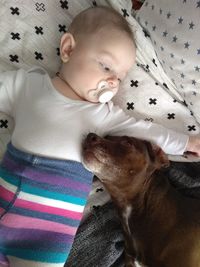 Cute baby lying on bed at home