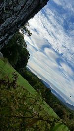 Scenic view of river against cloudy sky