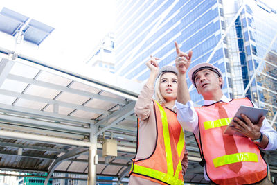 Low angle view of man looking at building