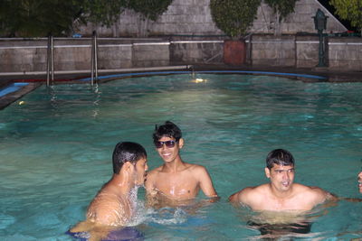 Young man swimming in pool