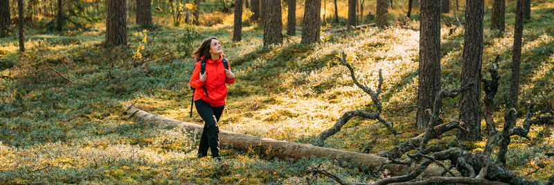 Rear view of woman walking in forest