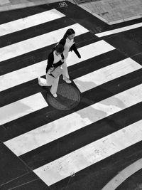 High angle view of men playing on zebra crossing