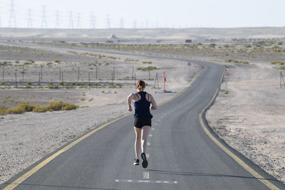 Full length of woman walking on road