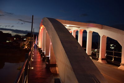 Illuminated bridge against sky at night