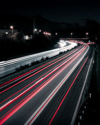 High angle view of light trails on highway at night