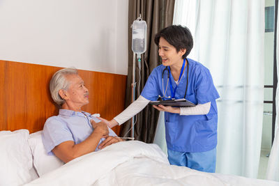 Side view of doctor examining patient in hospital