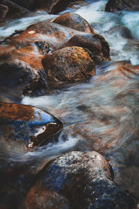 High angle view of river flowing through rocks