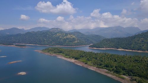 Scenic view of lake and mountains against sky