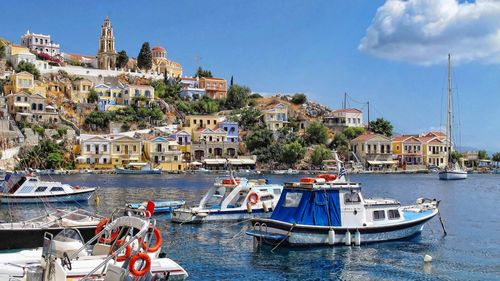 Boats in harbor with buildings in background