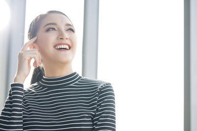 Portrait of a smiling young woman looking away